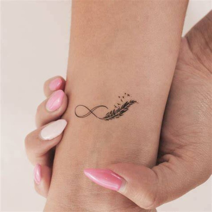 Breathtaking Feather Infinity Tattoo Ideas | Unleash Your Limitless Spirit